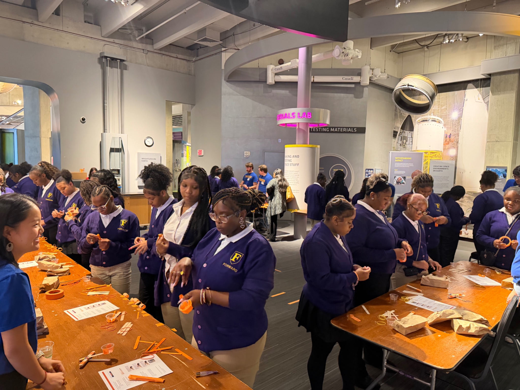 Students building projects together at a science exhibit