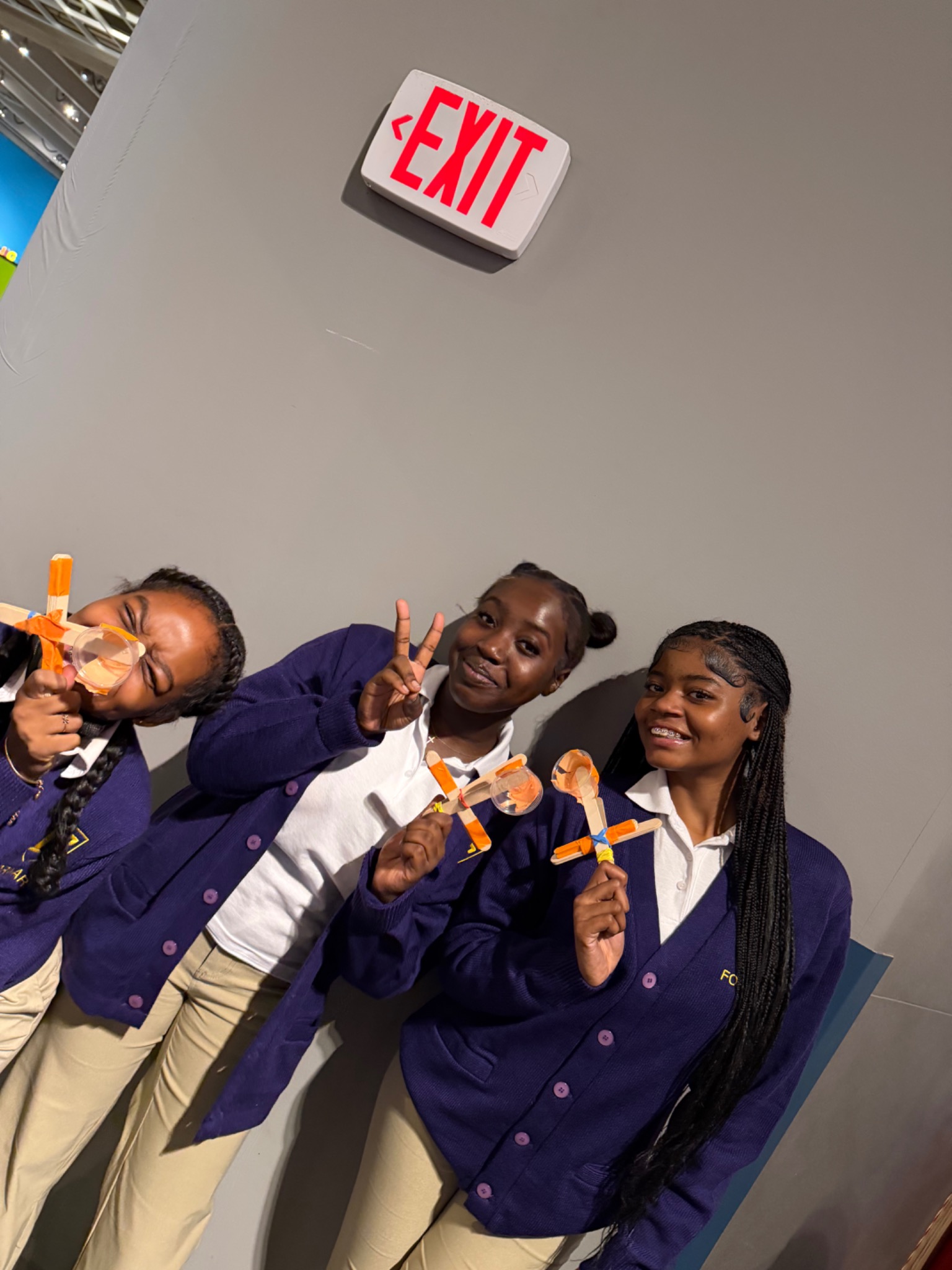 Three FORWARD students posing with their completed projects