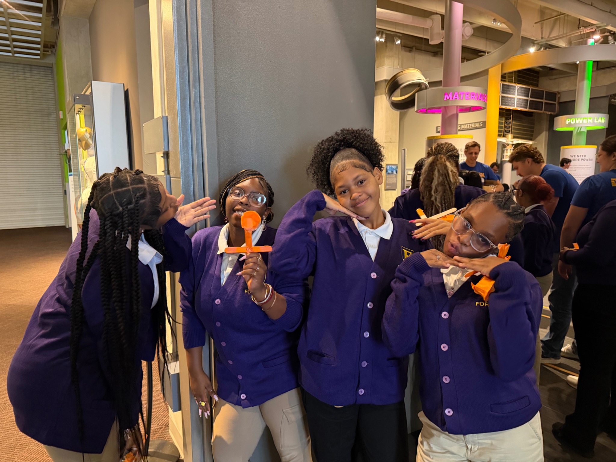 Four FORWARD students posing together with their projects