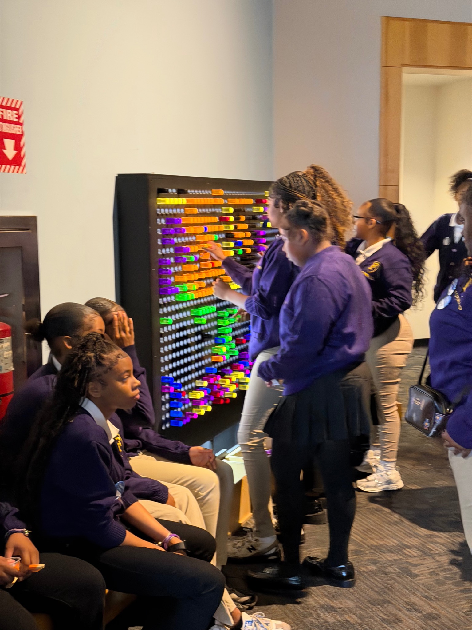 Students exploring an interactive exhibit together